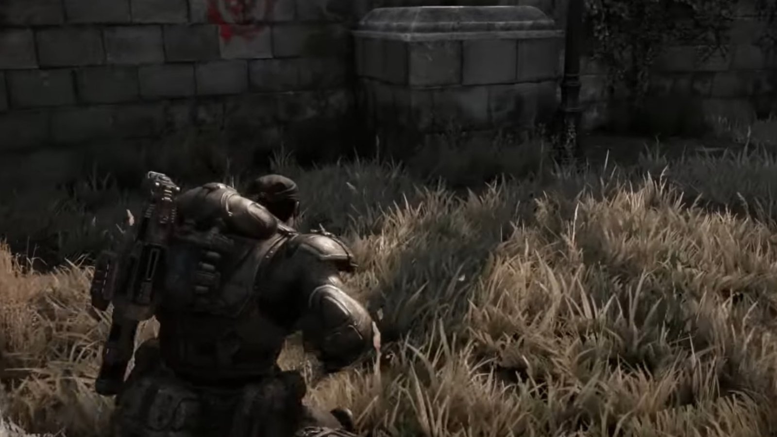 Gears of War: Reloaded screenshot featuring the red Gears of War icon by a column.