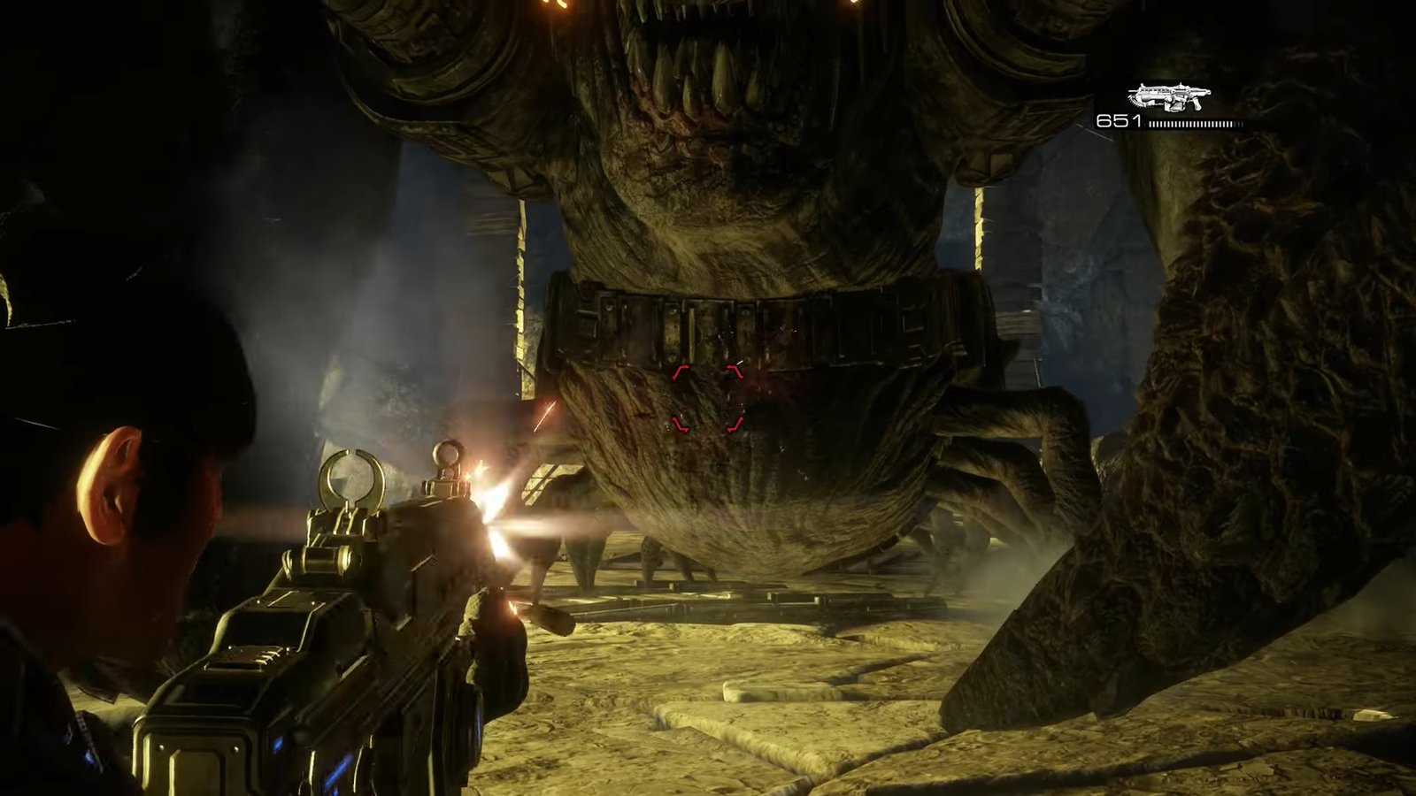 Gears of War: Reloaded screenshot featuring Marcus Fenix shooting at the underbelly of the Corpser.