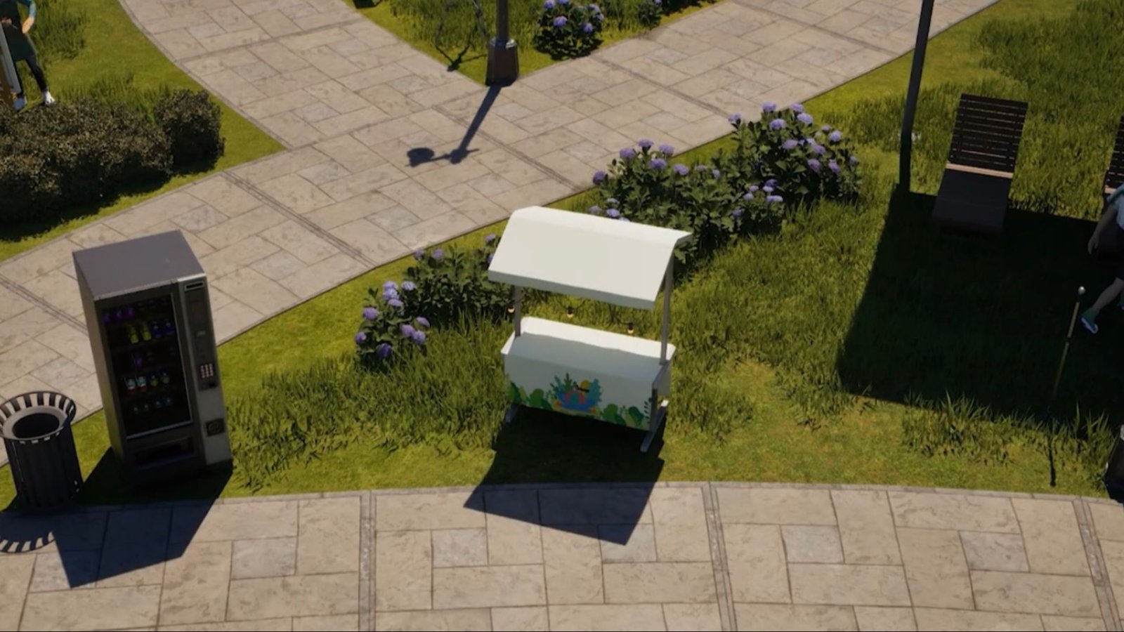 A screenshot from InZoi featuring a stall on a grassy area just by the sidewalk beside a vending machine. A screenshot from InZoi featuring a stall on a grassy area just by the sidewalk beside a vending machine.
