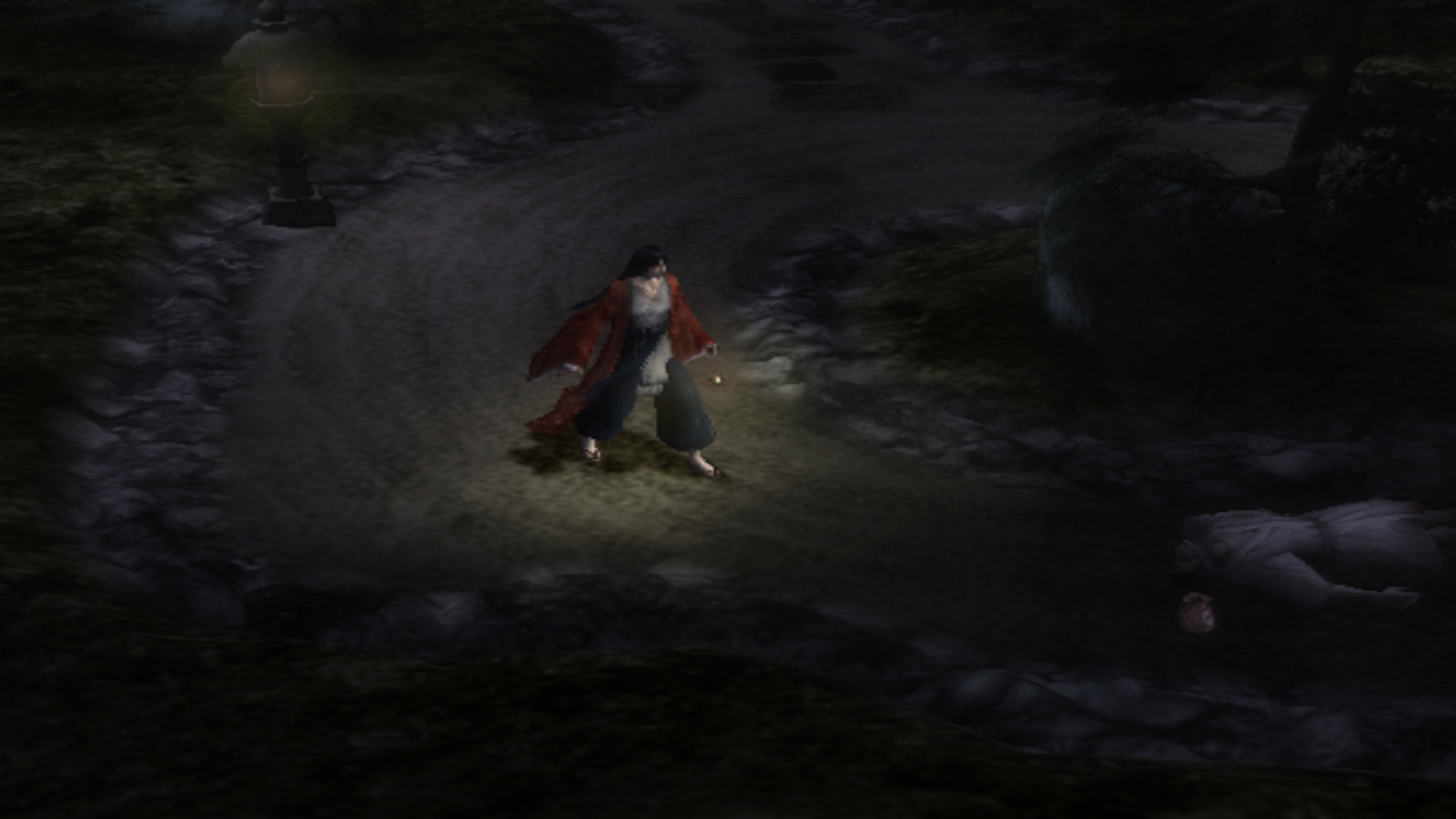 A still from Kuon showing a dark road and a ghostly figure walking down it.