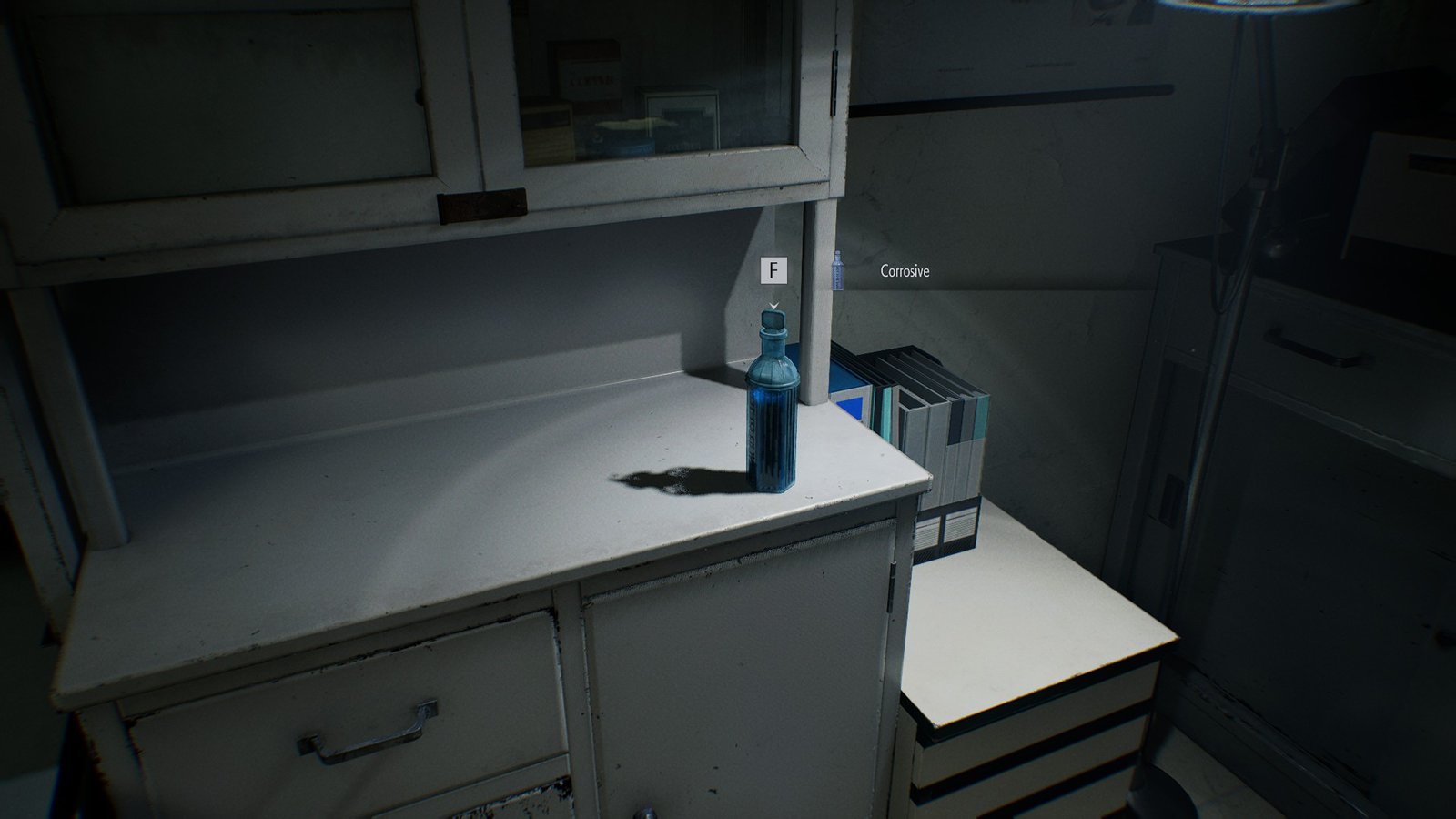 A blue bottle on top a medical cabinet RE9